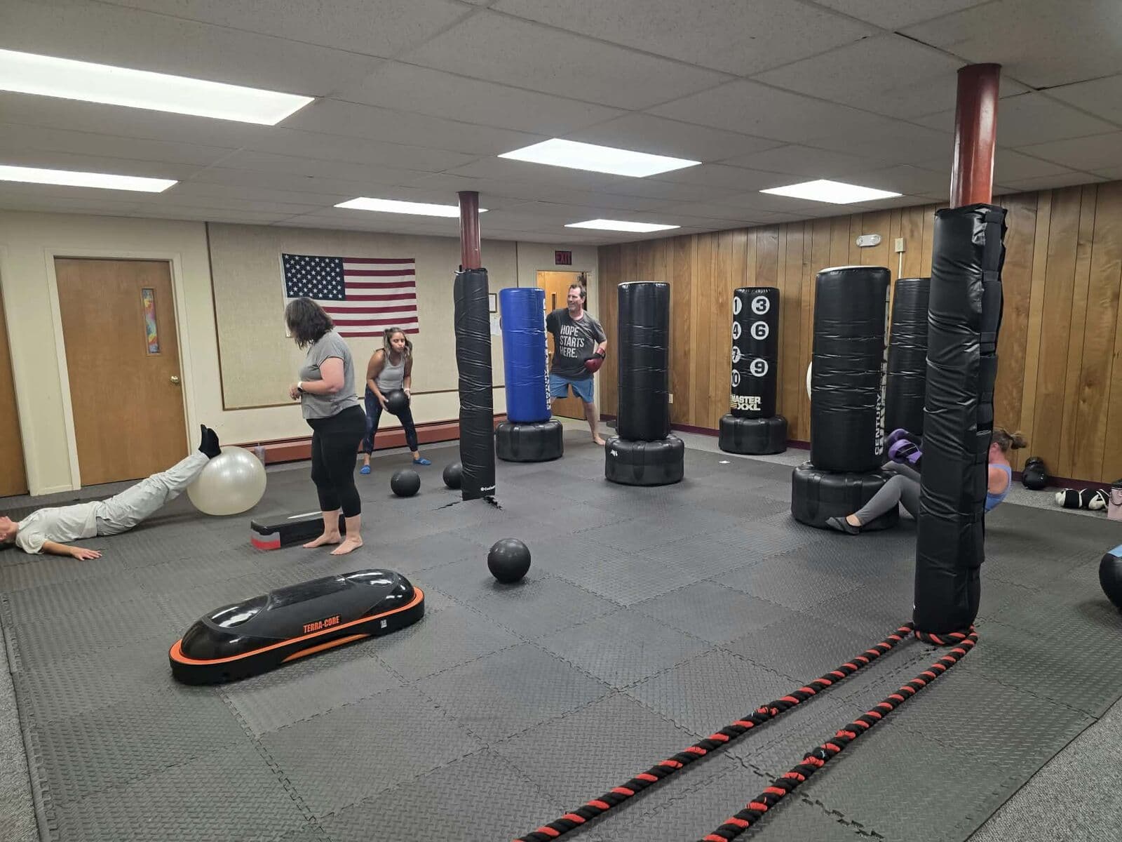 Training floor with heavy bags, medicine balls and battle ropes