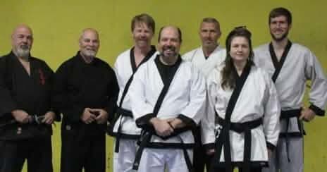 Tae Kwon Do black belts lined up in uniform